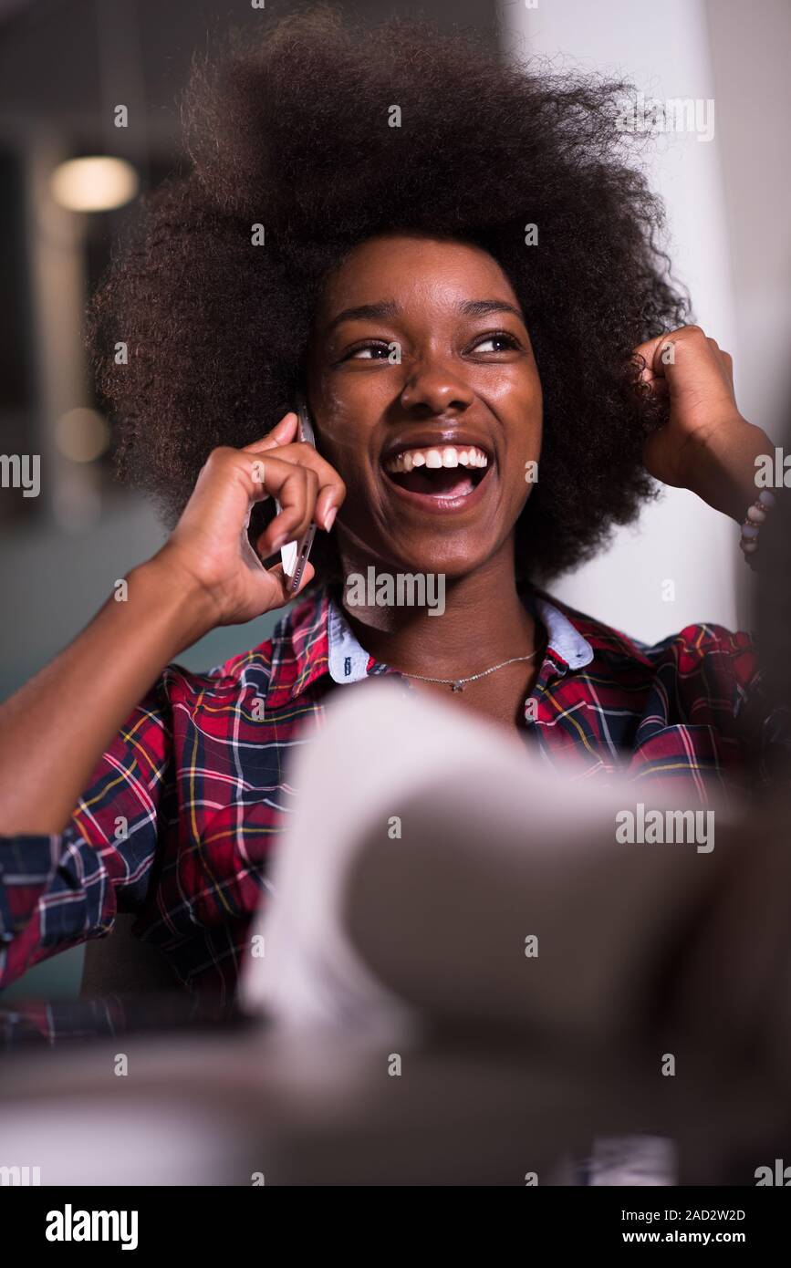portrait of a young successful African-American woman in modern office ...
