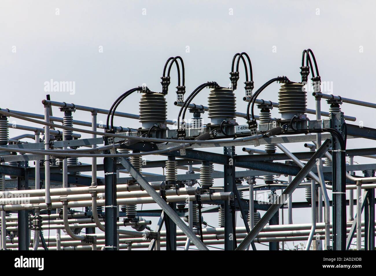 high voltage electrical substation tower top, close up on a closed electrical Isolator or Electrical Isolation Switch, Elements of a substation Stock Photo