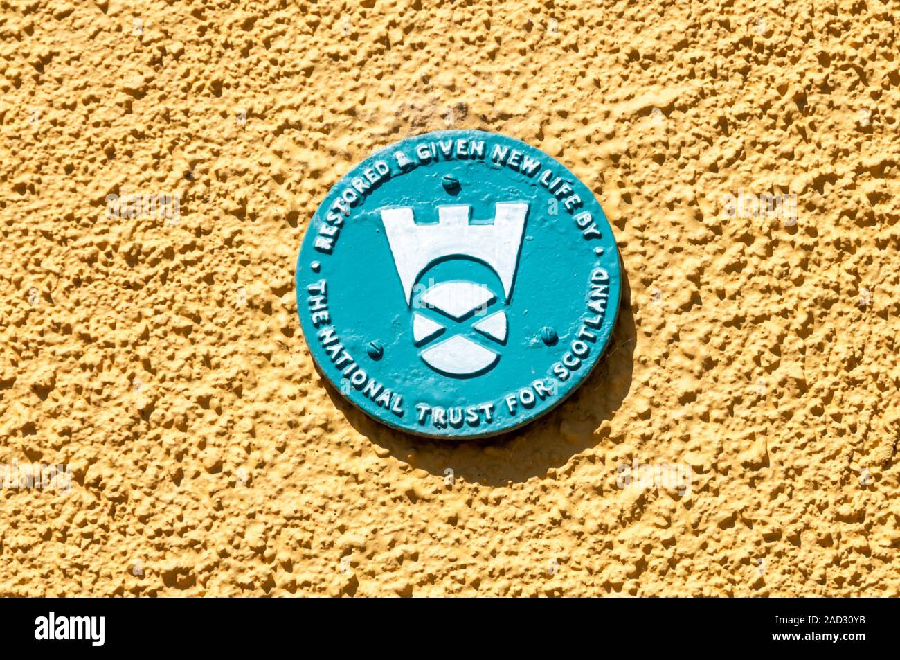 A National Trust for Scotland plaque on the wall of a restored building in St Monans, Fife, Scotland. Stock Photo