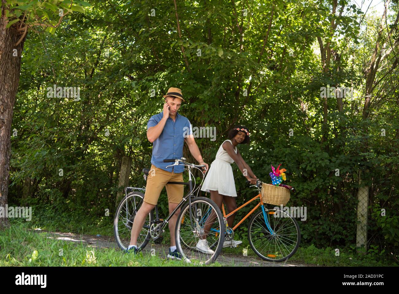 Young  couple having joyful bike ride in nature Stock Photo