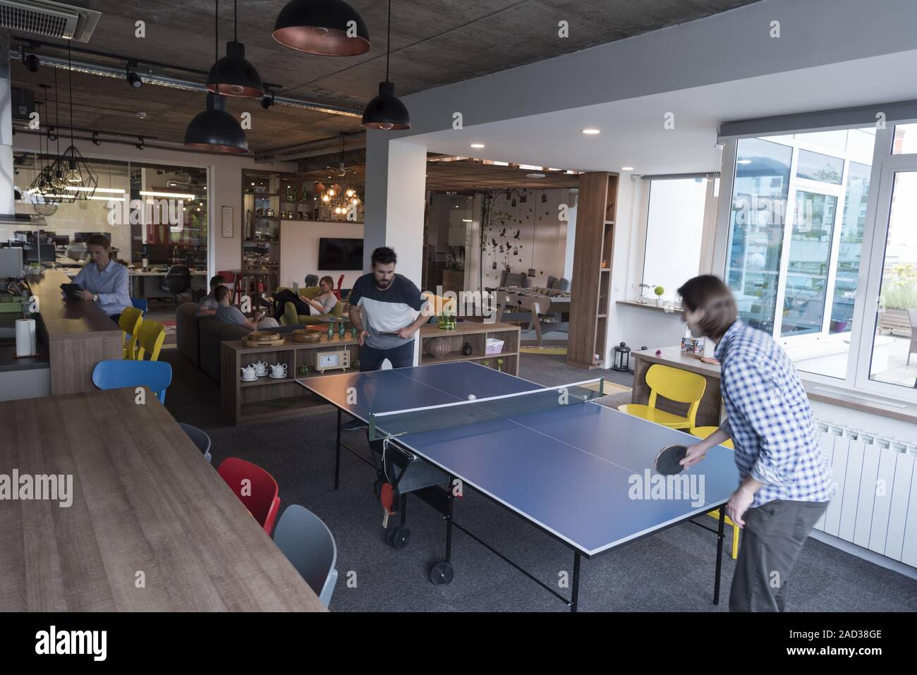playing ping pong tennis at creative office space Stock Photo - Alamy