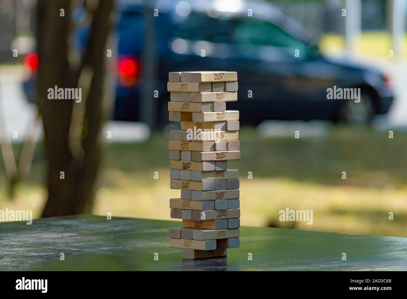 Jenga tower in a public park in the city. Side view. Concept. Surgut, Russia - September 25, 2019. Stock Photo
