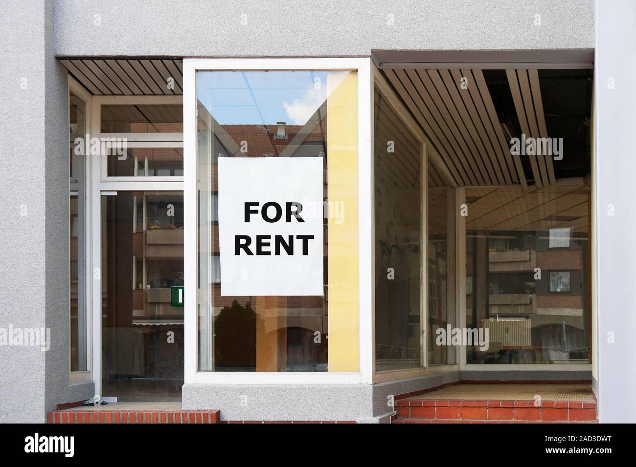 for rent sign in empty shop window Stock Photo