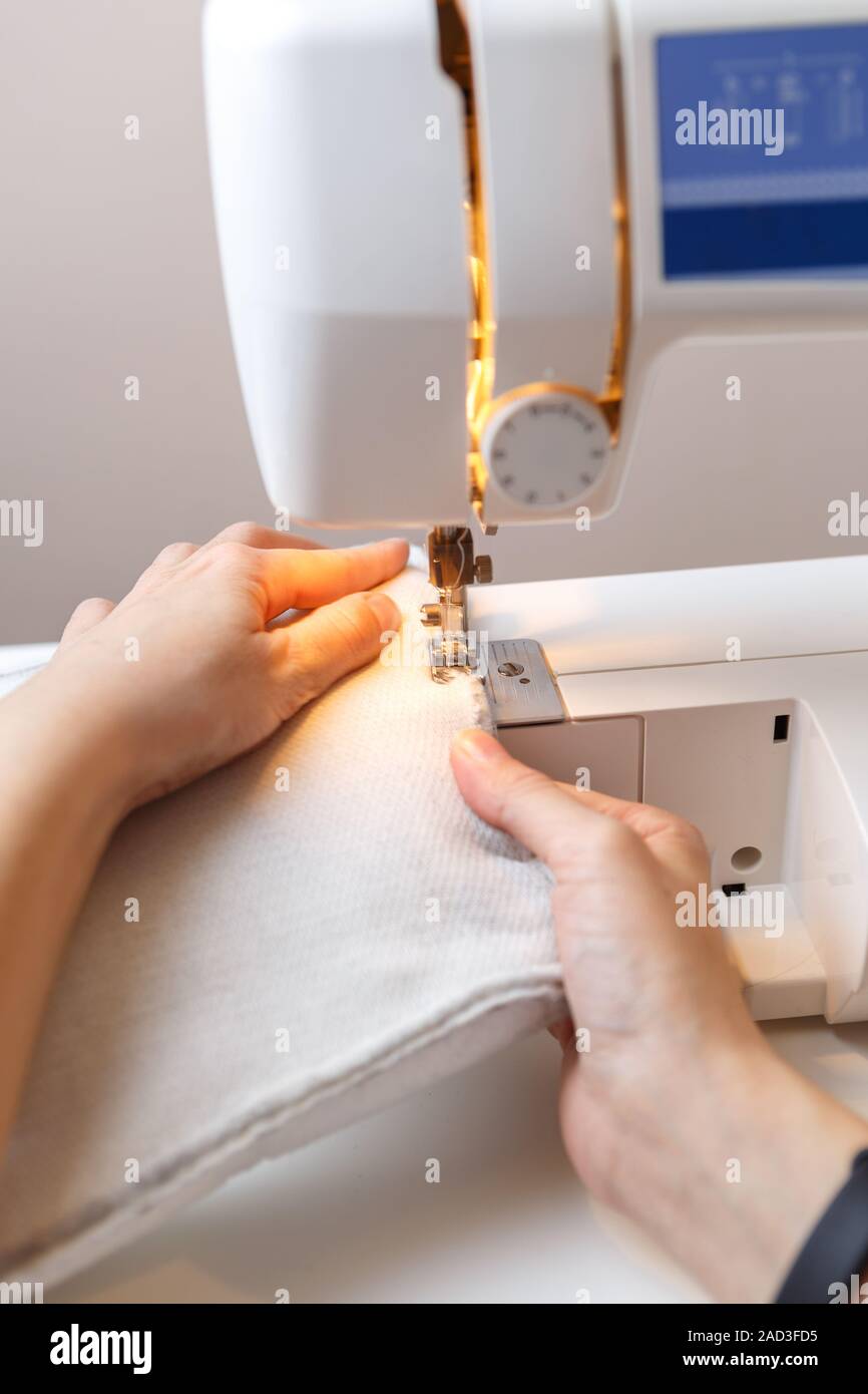 Seamstress working at sewing machine Stock Photo