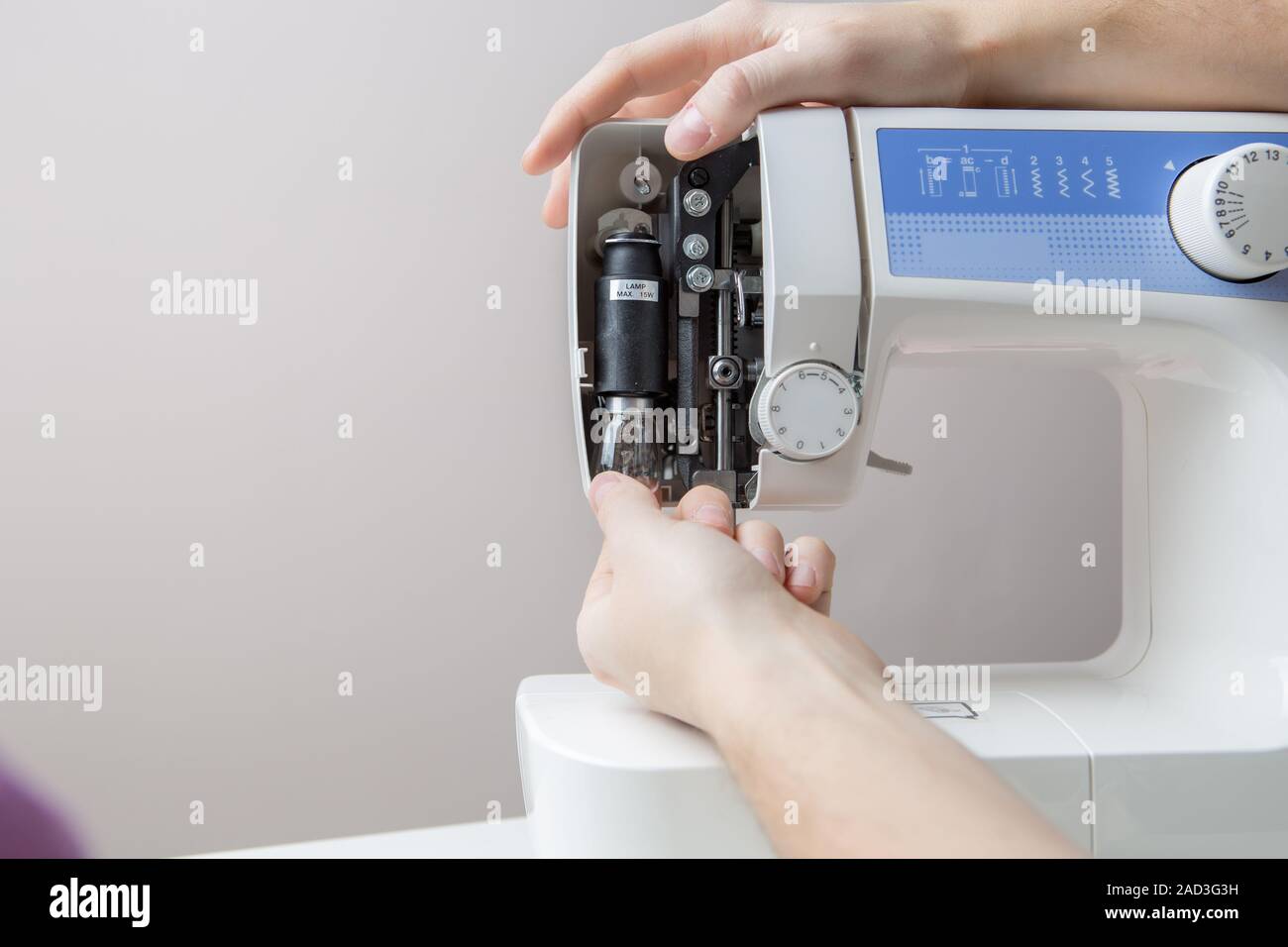 Master repairing white sewing machine Stock Photo