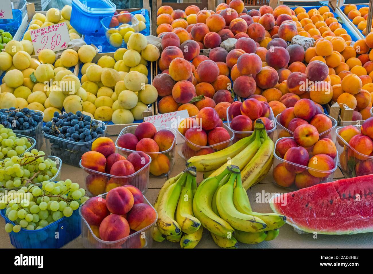 Different kinds of peaches and other fruits for sale at a market in