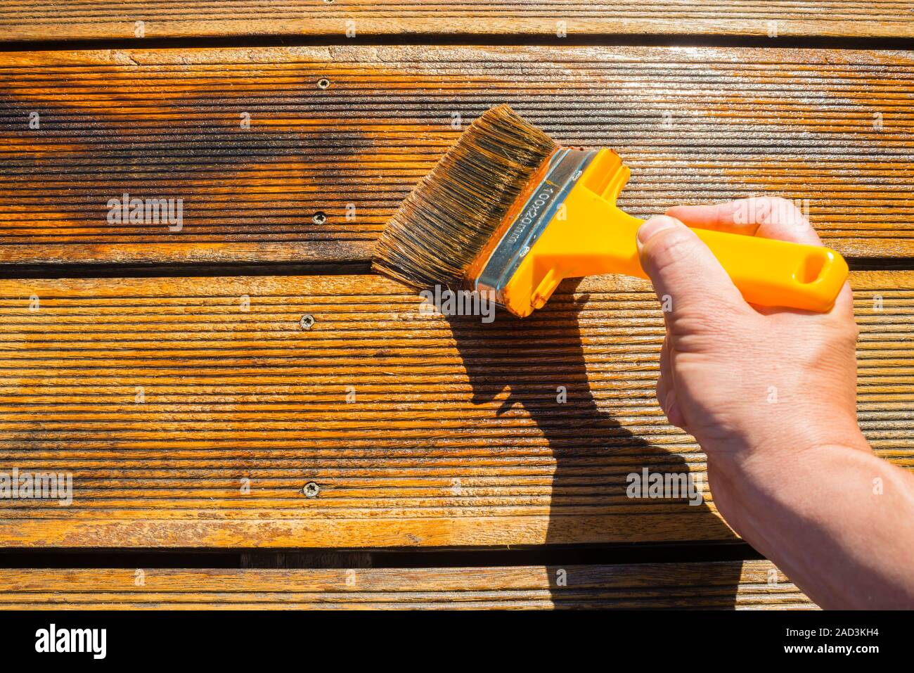 Oiling Terrace with Wide Brush painting wooden patio deck with