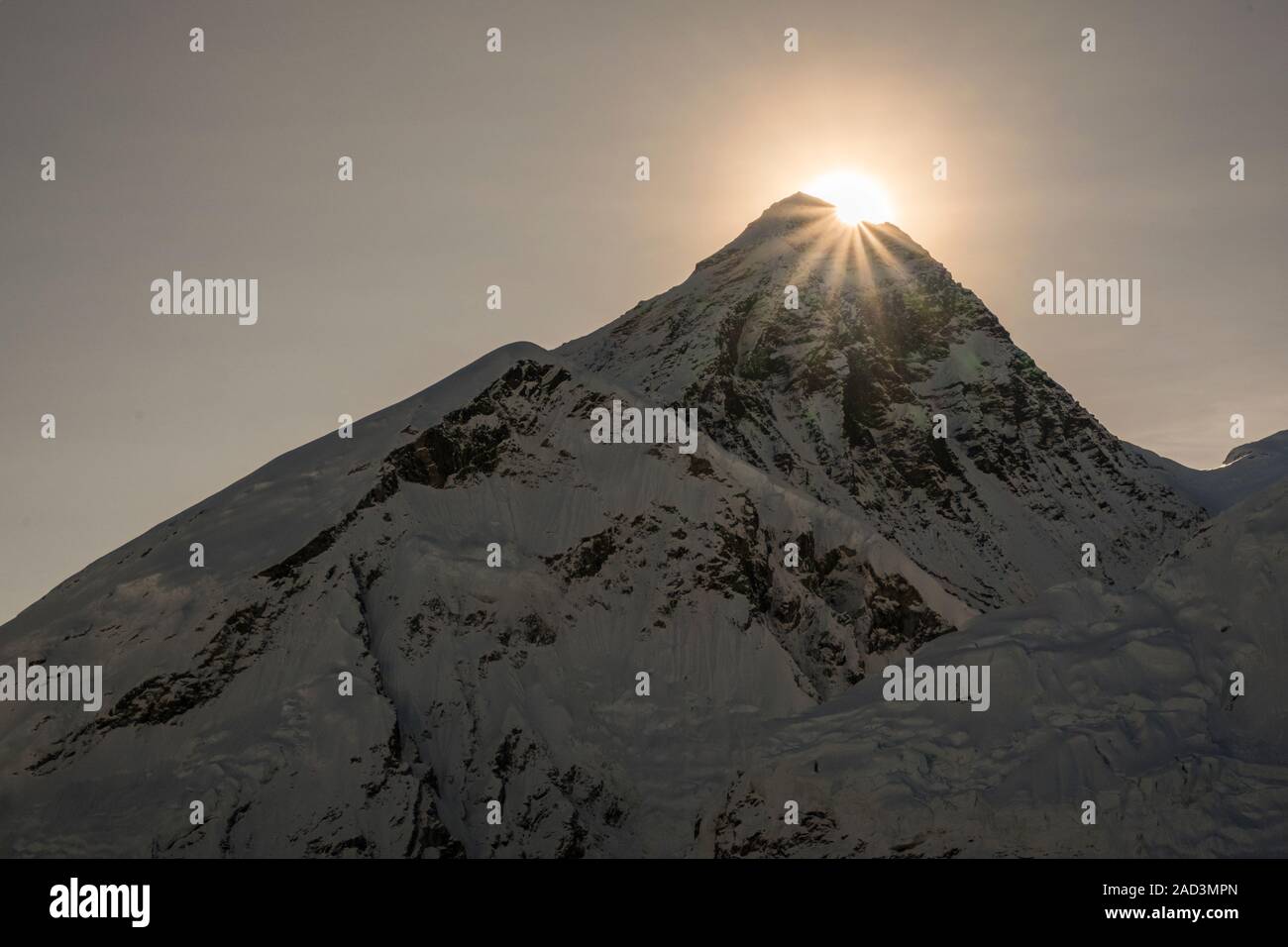 The sun is rising behind the summit of Mt. Everest, seen from the top of Kala Patthar Stock Photo