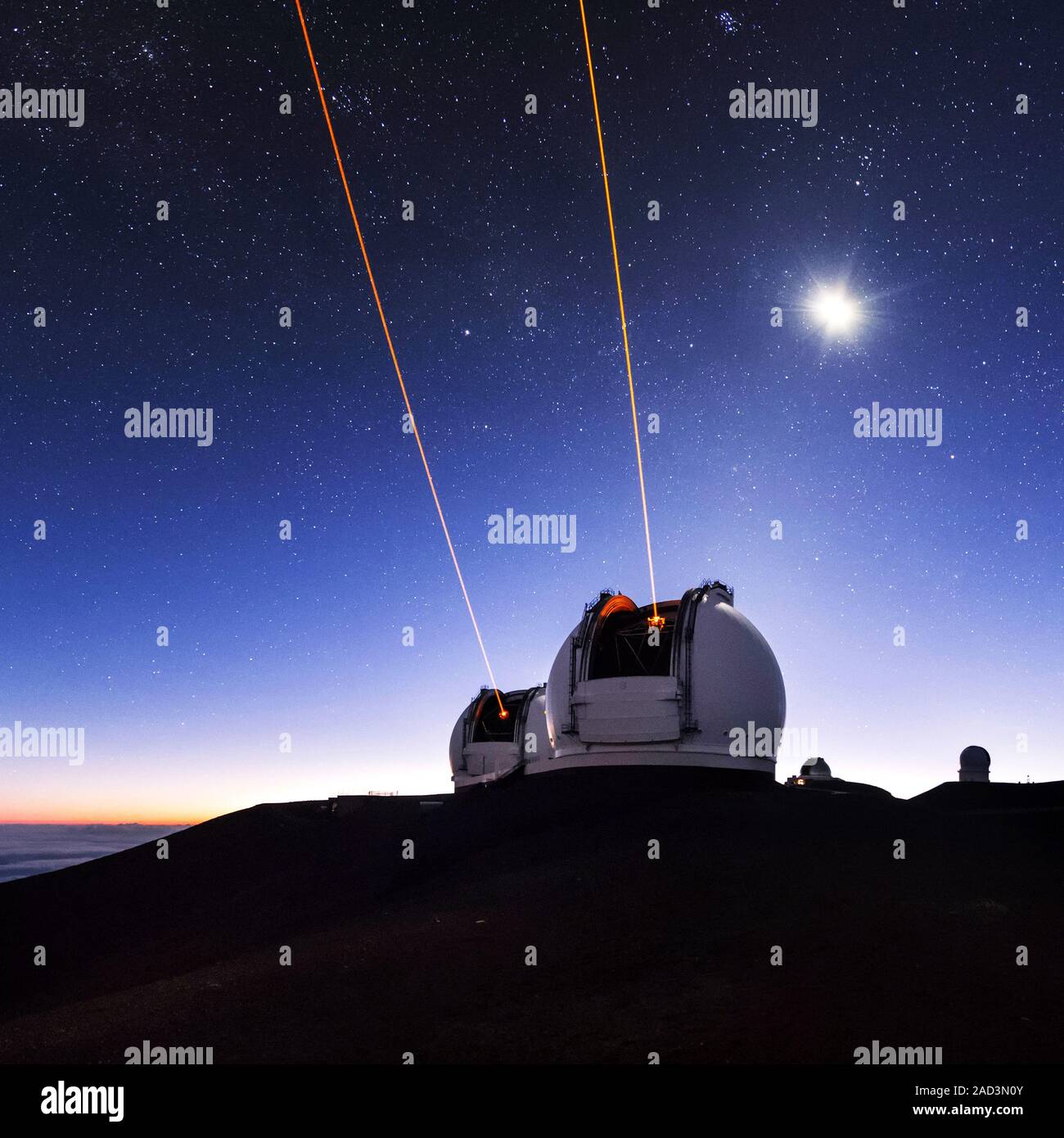 Guide lasers over Mauna Kea observatories. The lasers emerging from the twin Keck telescopes are