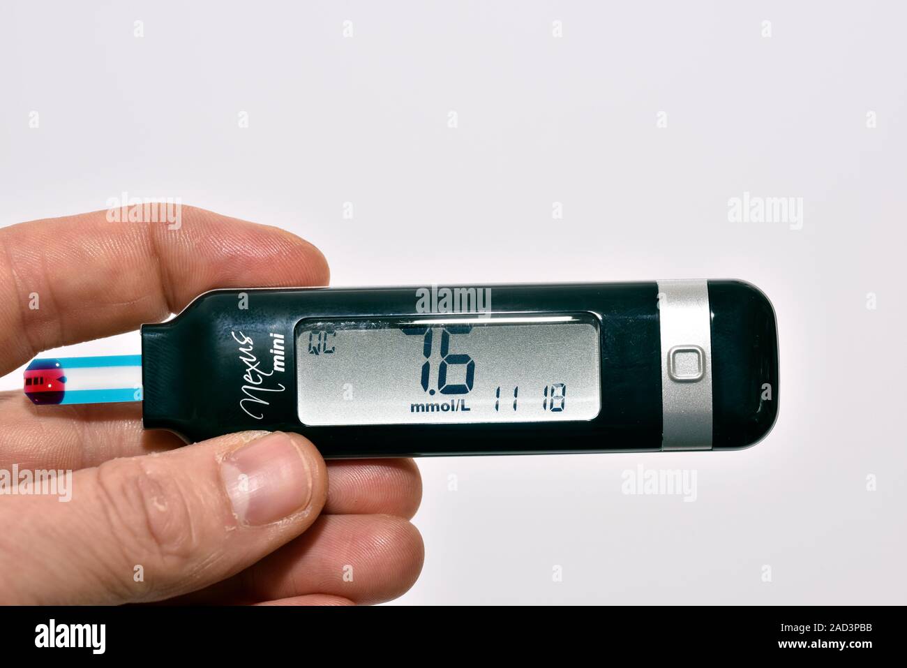 Blood glucose monitor. Person holding a digital monitor