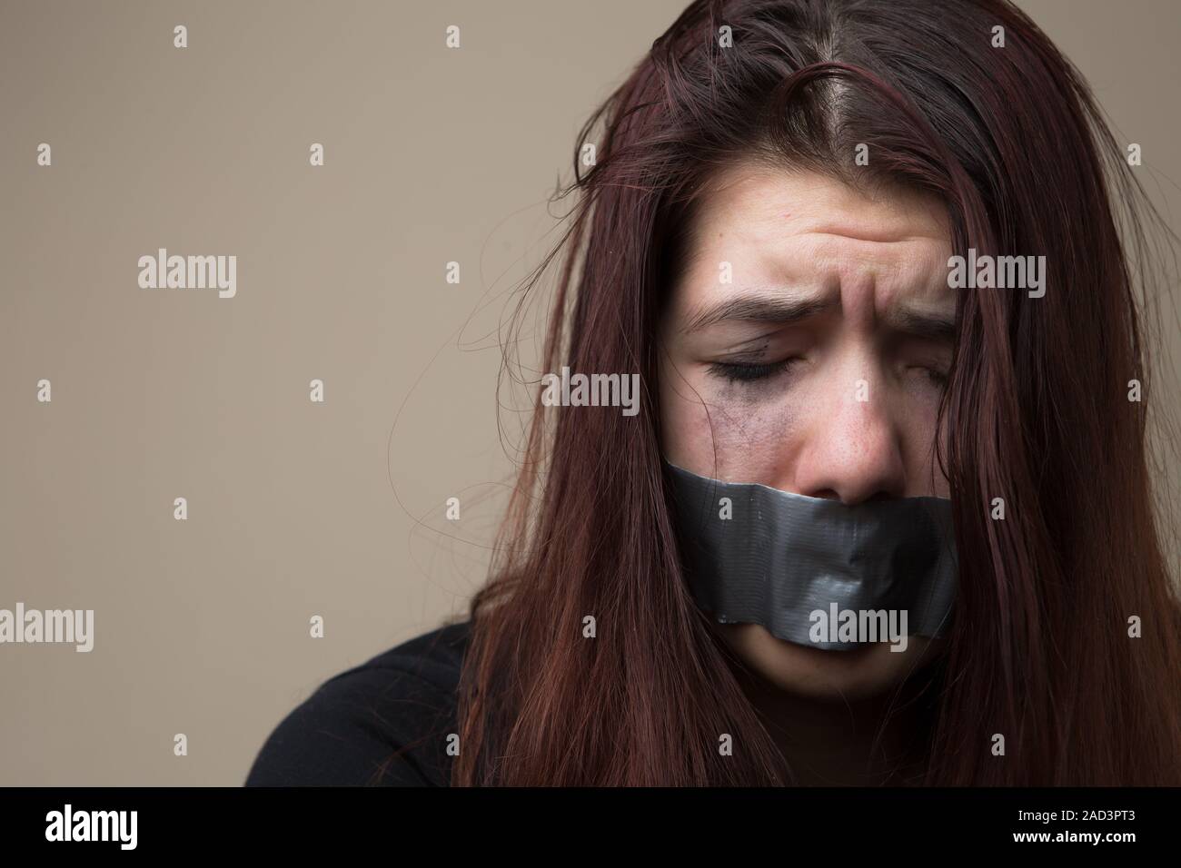 Crying woman with gray tape Stock Photo
