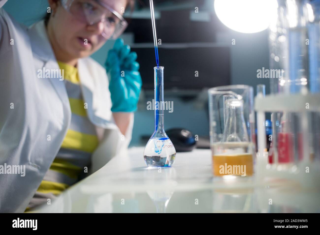Lab technician in protective glasses Stock Photo