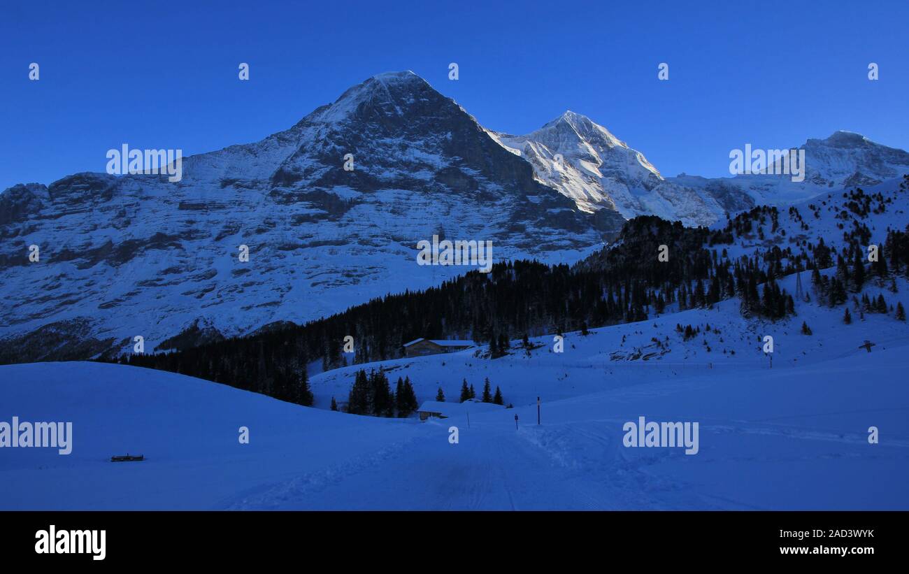 Eiger north face in winter. Famous mountains Eiger, Monch and Jungfrau ...