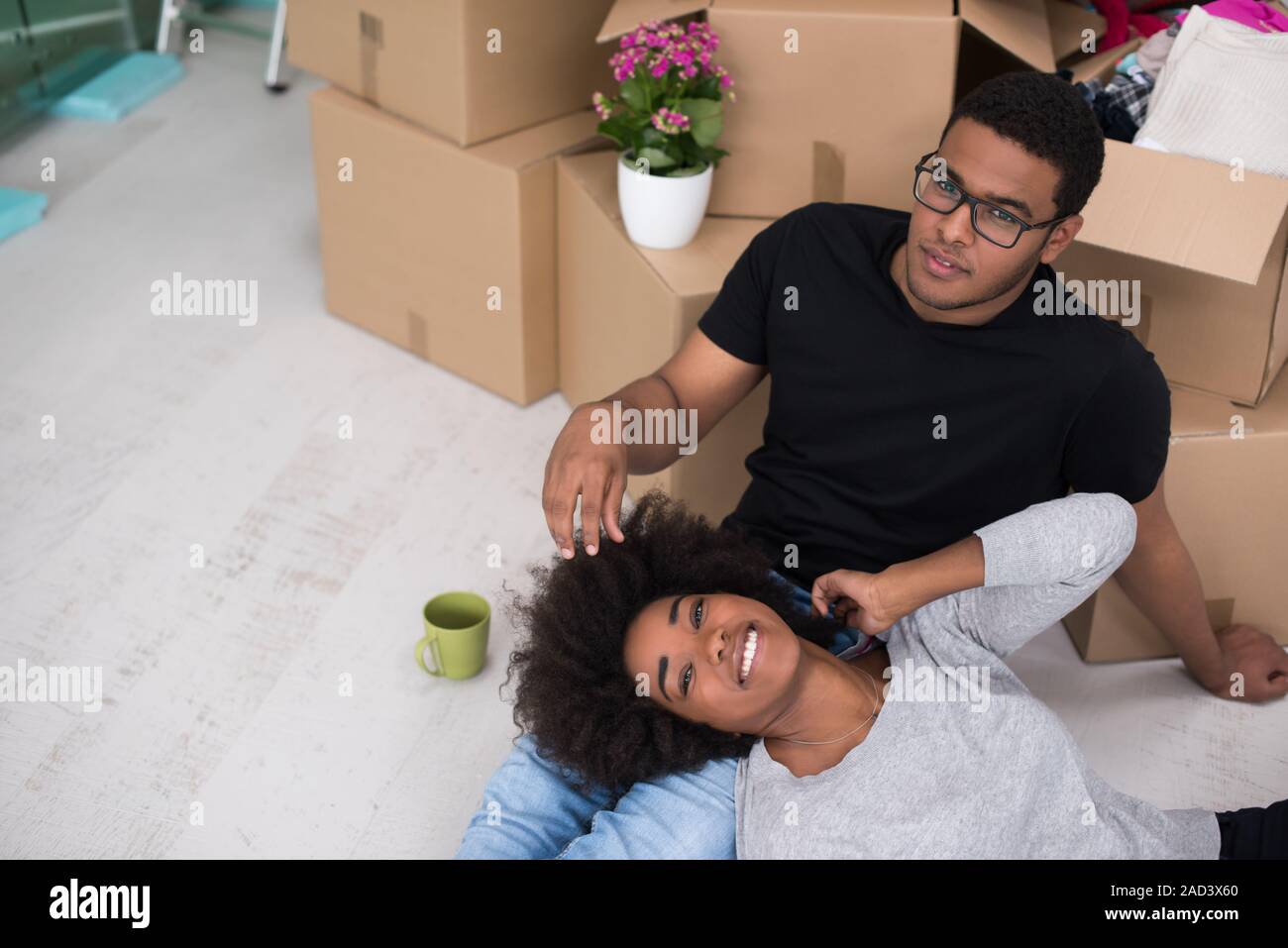 African American couple relaxing in new house Stock Photo - Alamy