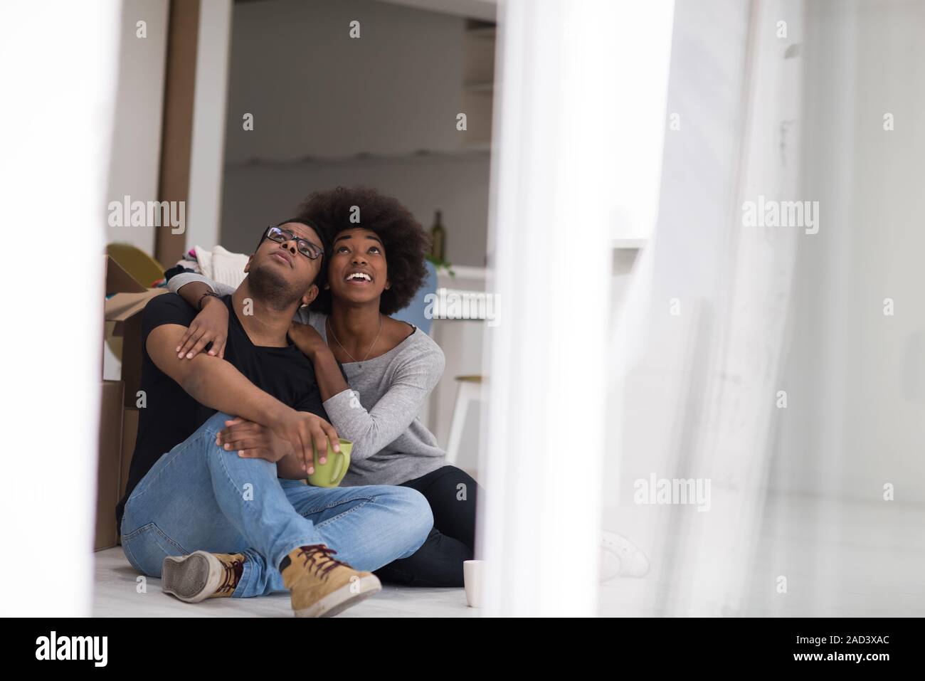 African American couple relaxing in new house Stock Photo - Alamy