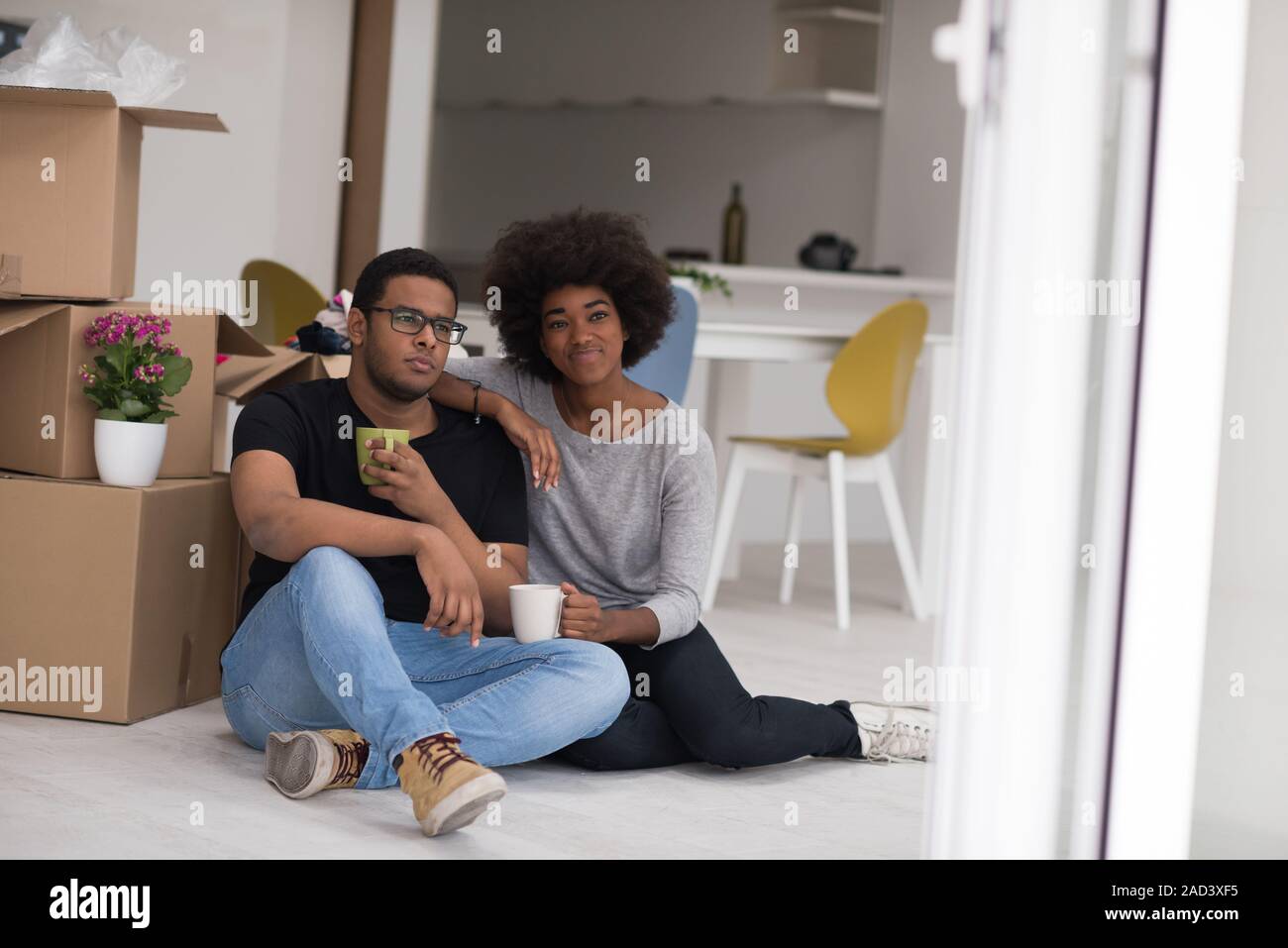 African American couple relaxing in new house Stock Photo - Alamy