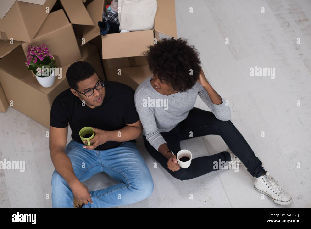African American couple relaxing in new house Stock Photo - Alamy