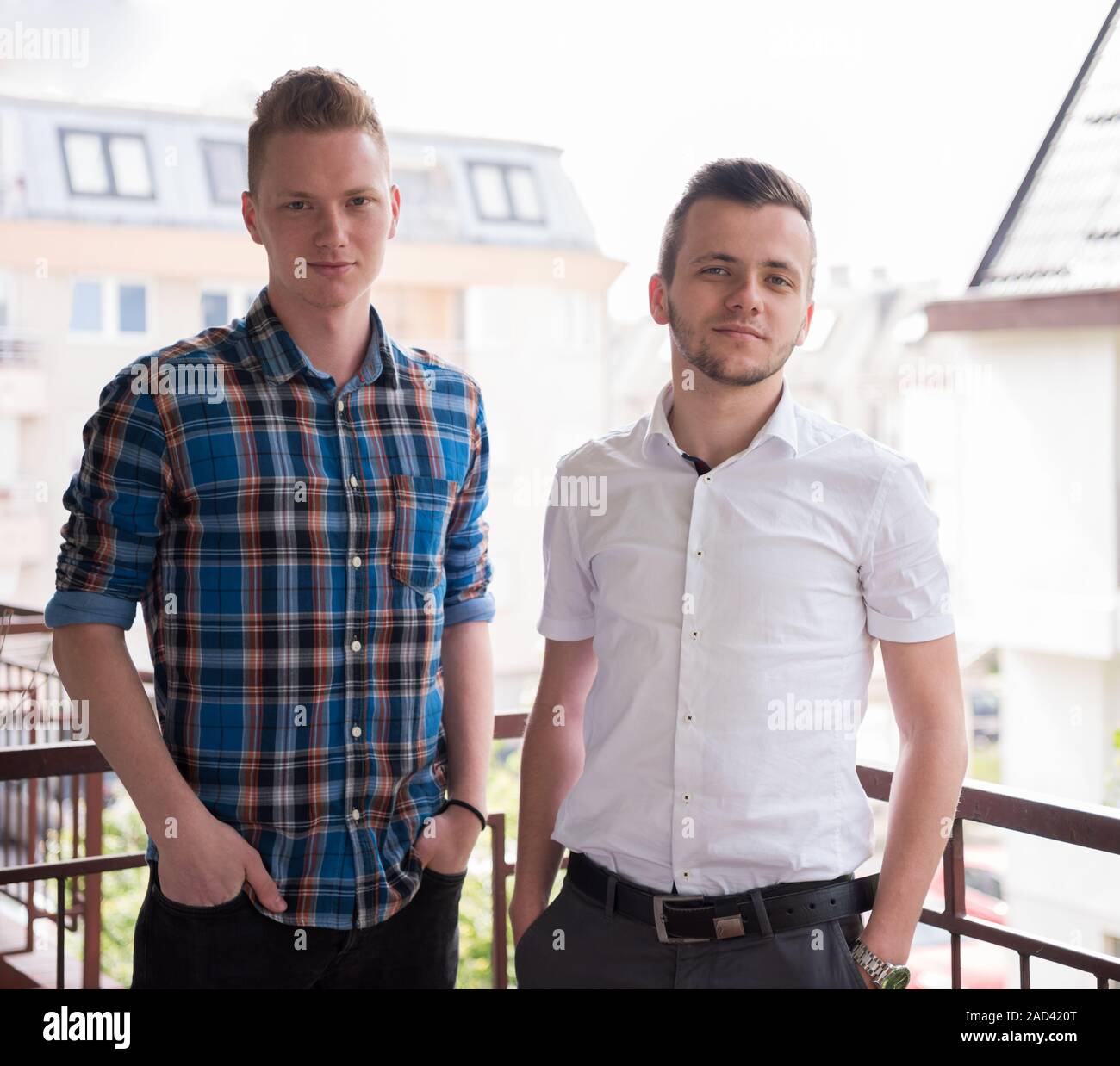 two young men standing at balcony Stock Photo - Alamy