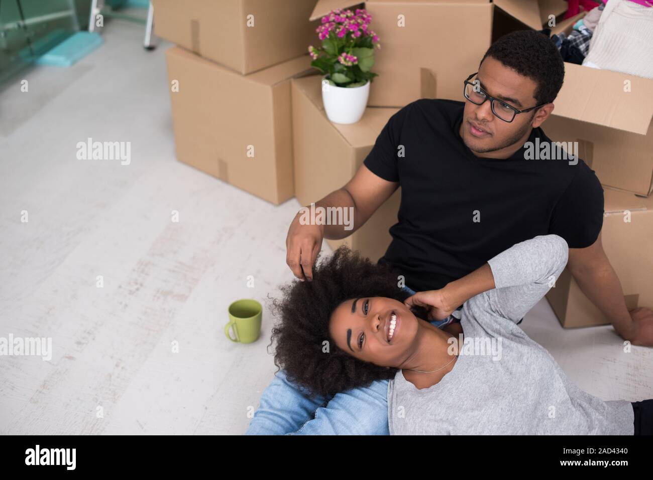 African American couple relaxing in new house Stock Photo - Alamy