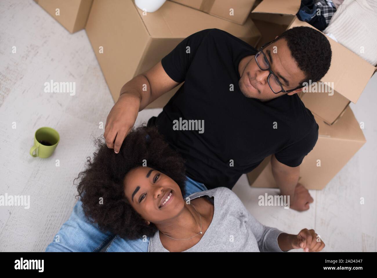 African American couple relaxing in new house Stock Photo - Alamy
