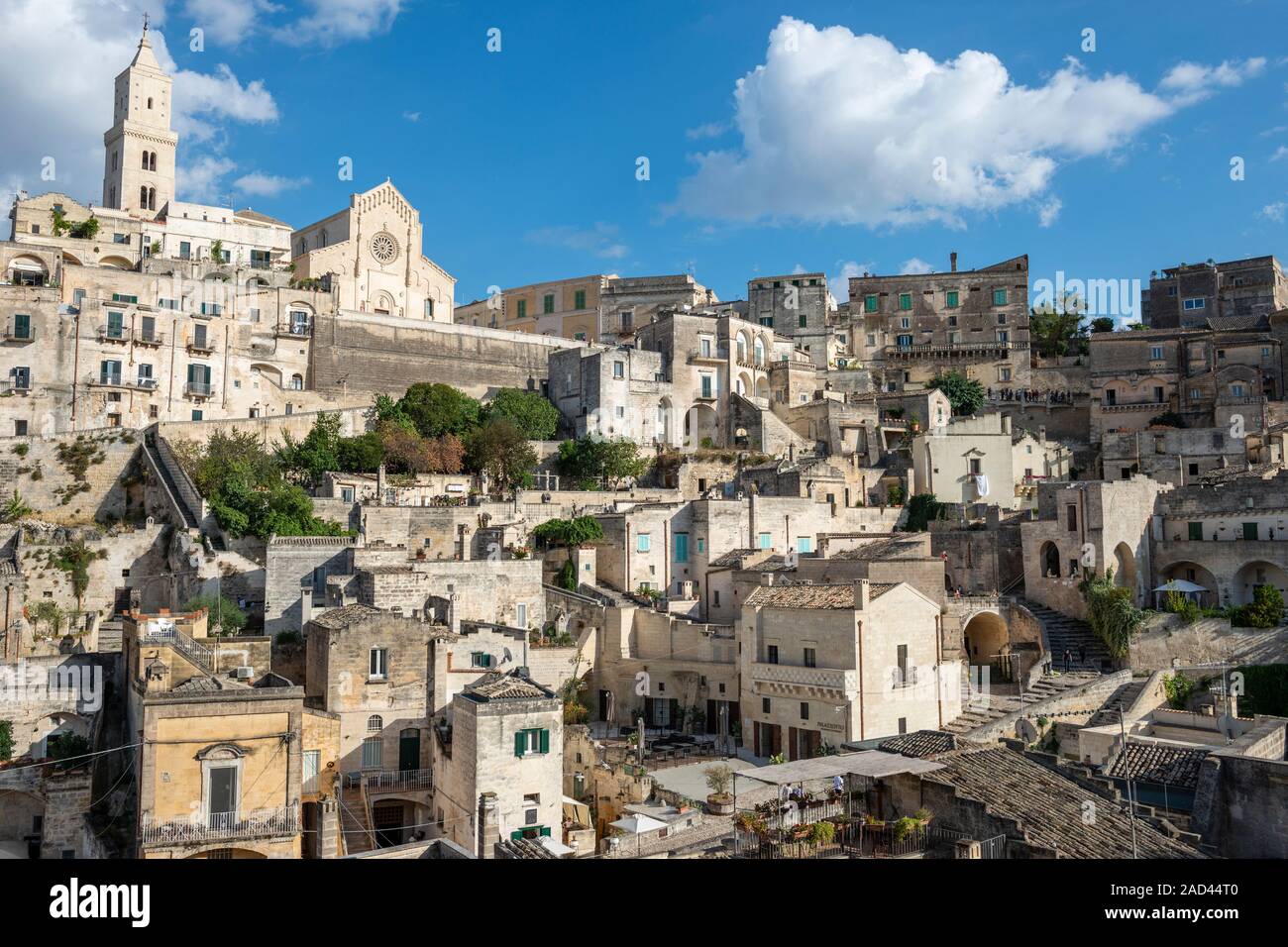 General view across Sasso Barisano with cathedral tower in distance - Sassi District of Matera, Basilicata Region, Southern Italy Stock Photo