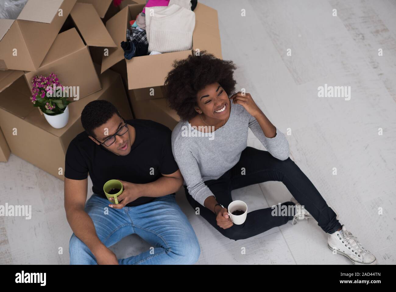 African American couple relaxing in new house Stock Photo - Alamy