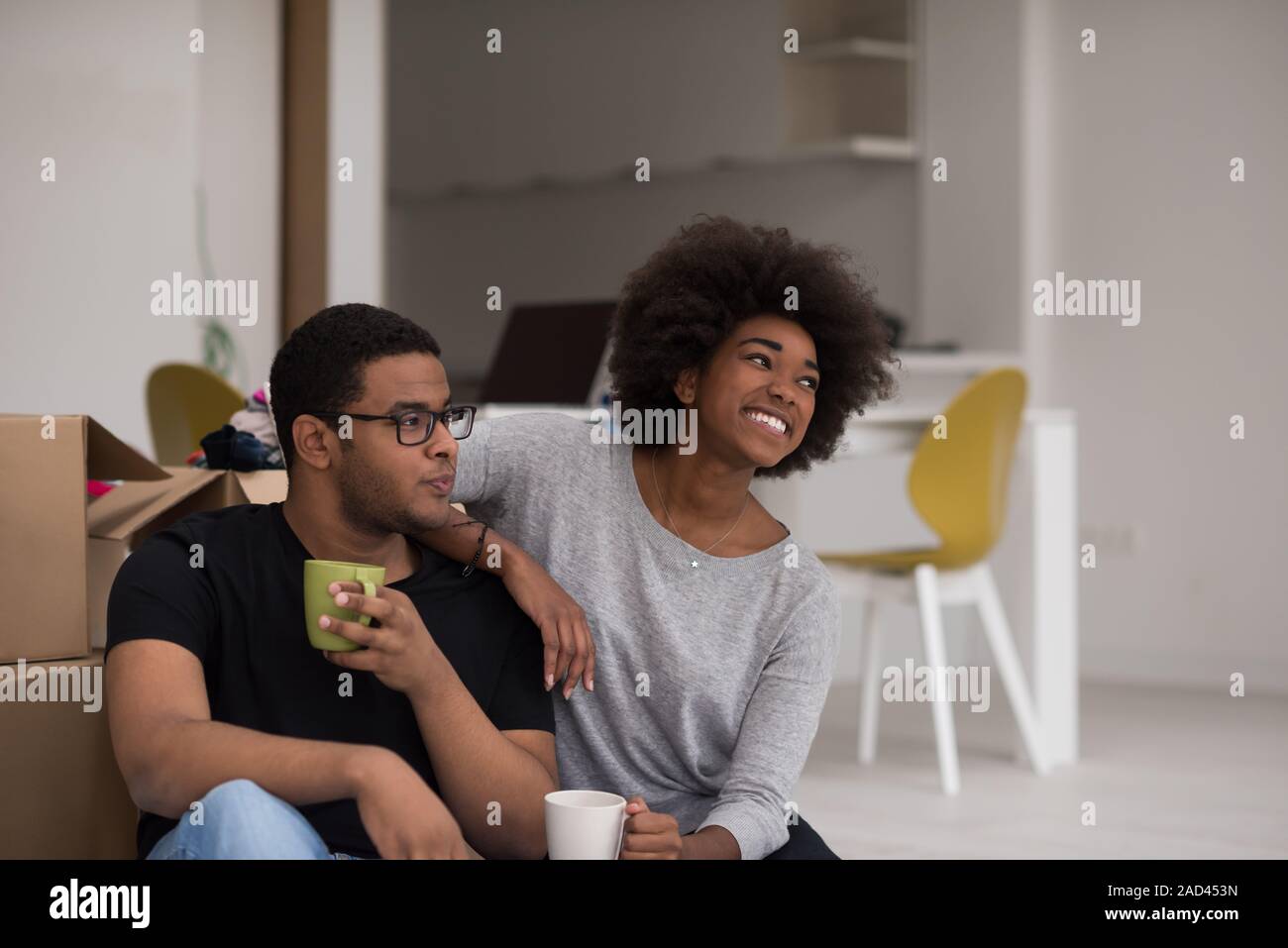 African American couple relaxing in new house Stock Photo - Alamy