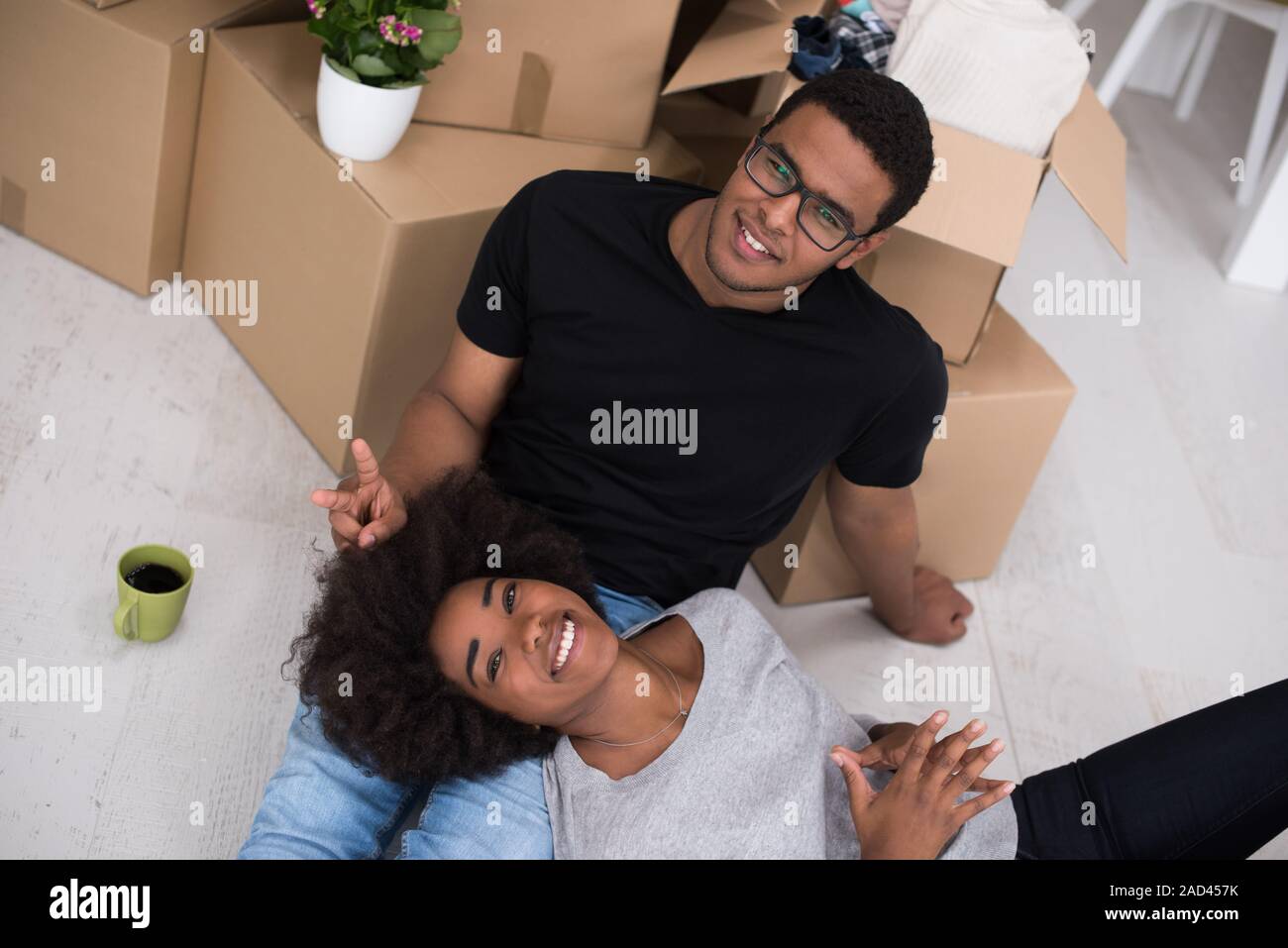 African American couple relaxing in new house Stock Photo - Alamy