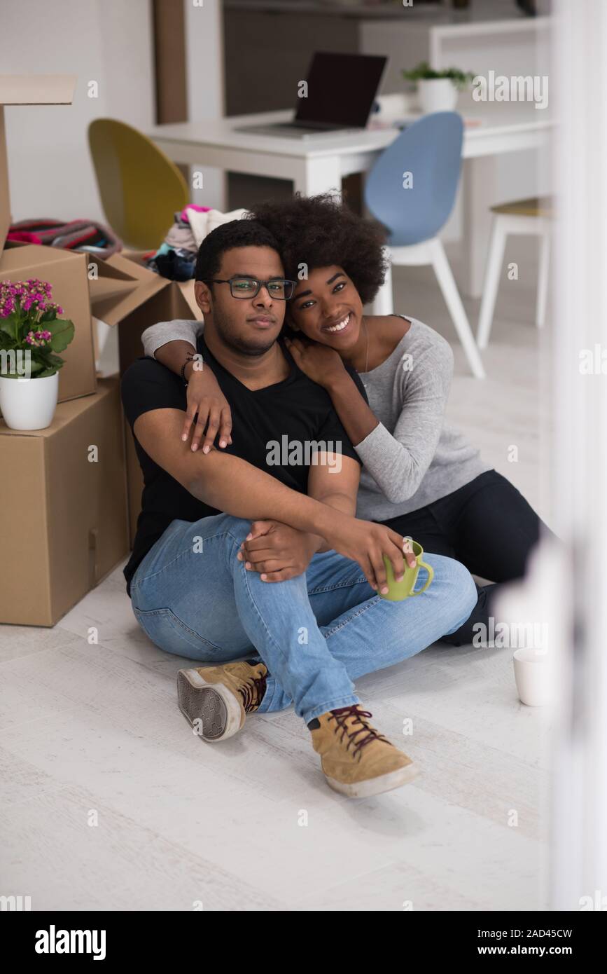 African American couple relaxing in new house Stock Photo - Alamy