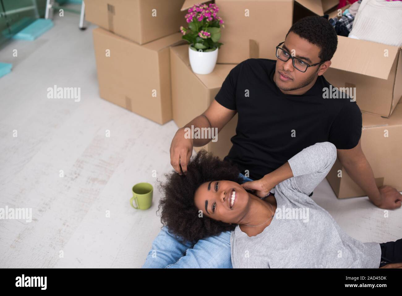 African American couple relaxing in new house Stock Photo - Alamy
