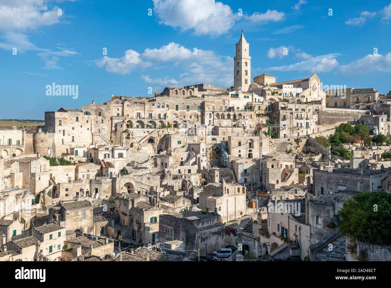 General view across Sasso Barisano with cathedral tower in distance - Sassi District of Matera, Basilicata Region, Southern Italy Stock Photo