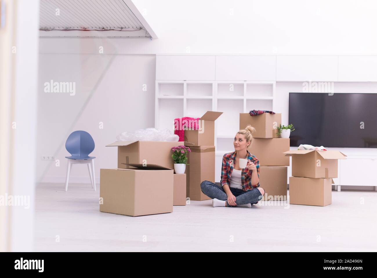 woman with many cardboard boxes sitting on floor Stock Photo - Alamy