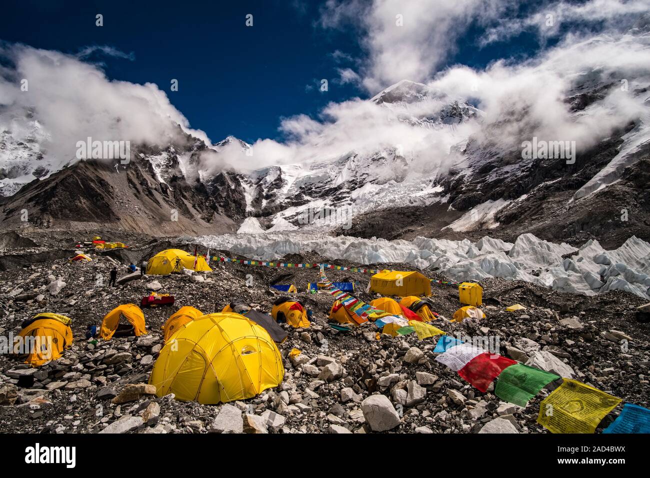 Tents set up at Everest Base Camp on Khumbu glacier, Mt. Everest behind covered by monsoon clouds Stock Photo