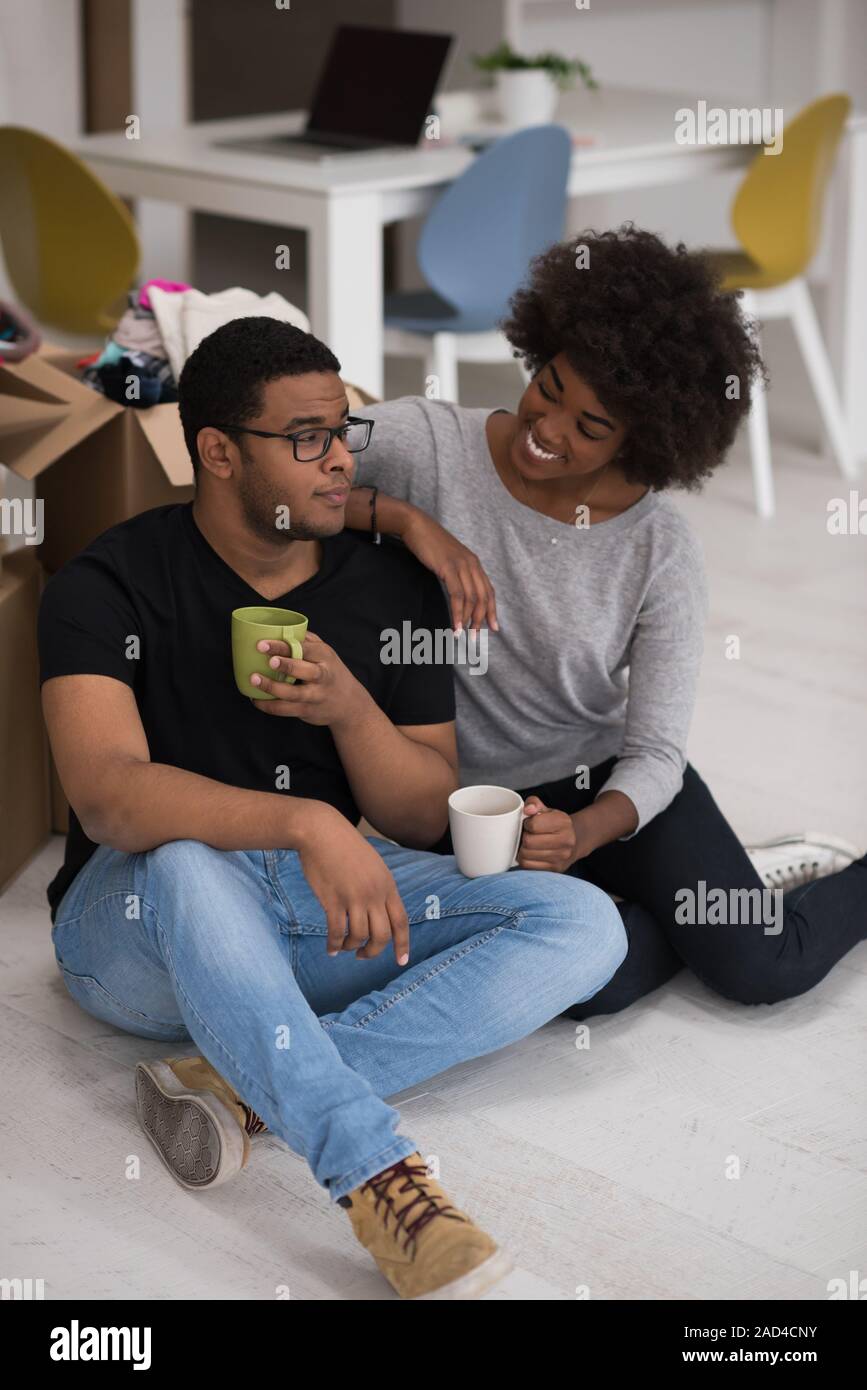 African American couple relaxing in new house Stock Photo - Alamy