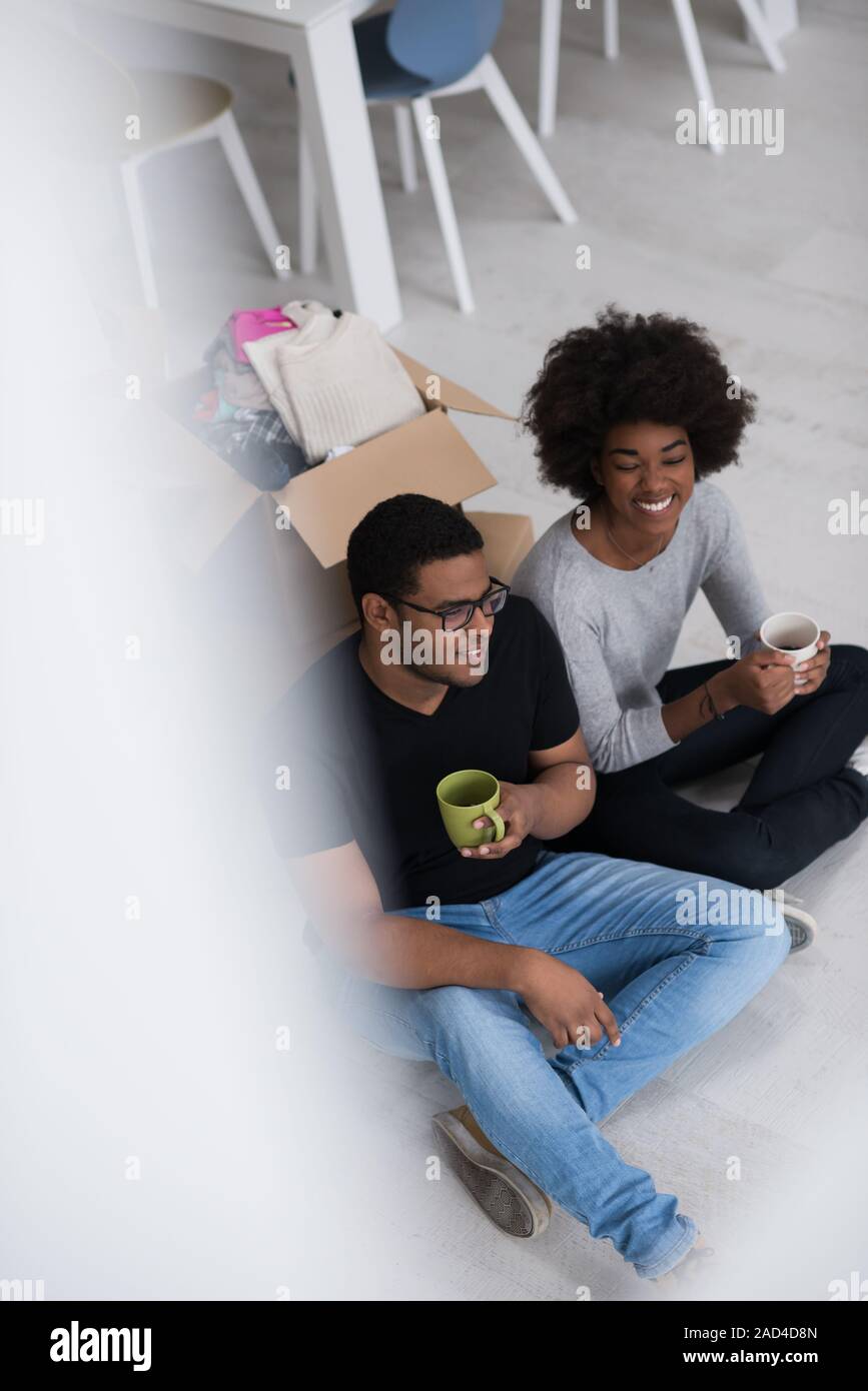 African American couple relaxing in new house Stock Photo - Alamy