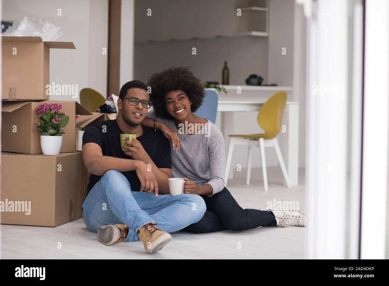 African American couple relaxing in new house Stock Photo - Alamy