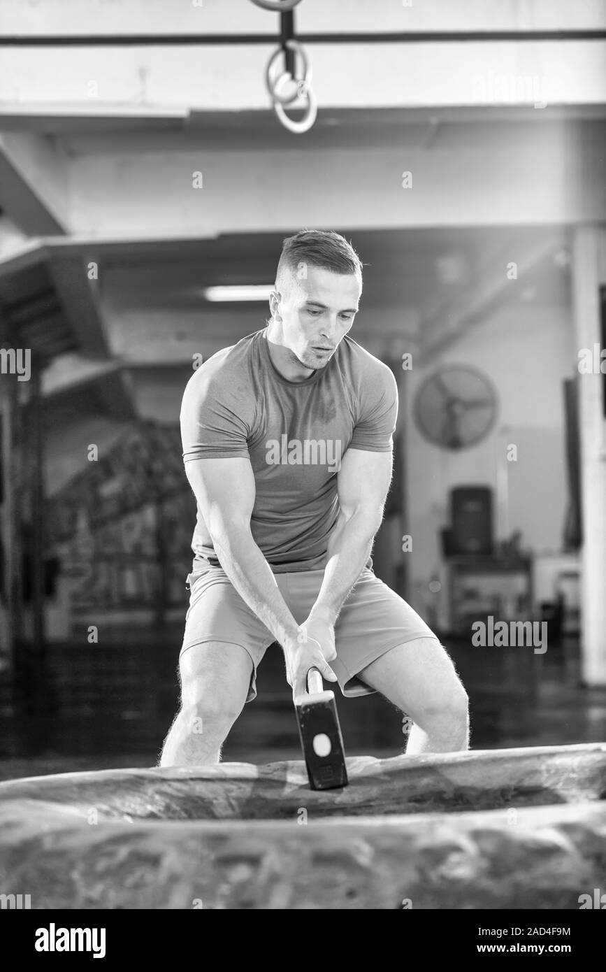 man workout with hammer and tractor tire Stock Photo Alamy