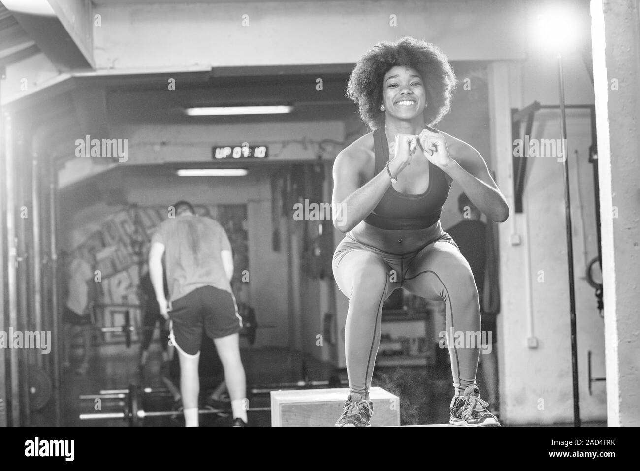 black female athlete is performing box jumps at gym Stock Photo - Alamy