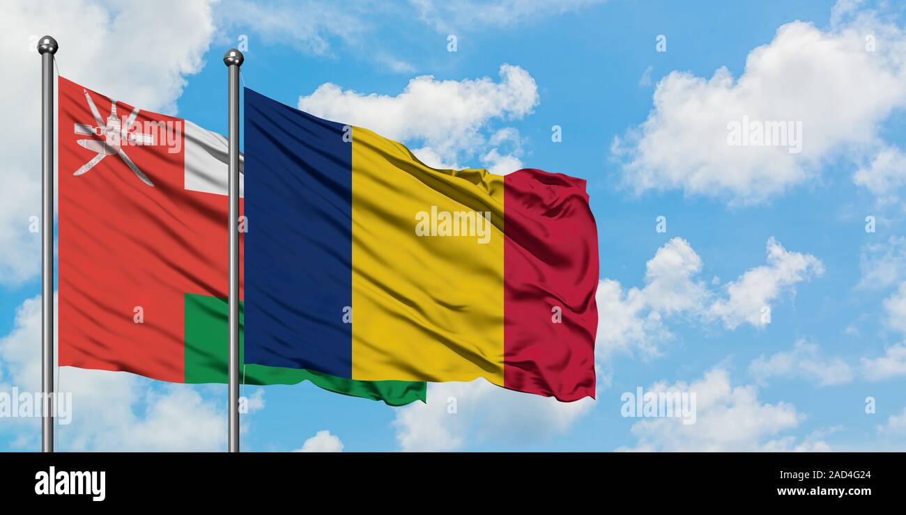 Oman and Chad flag waving in the wind against white cloudy blue sky together. Diplomacy concept, international relations. Stock Photo
