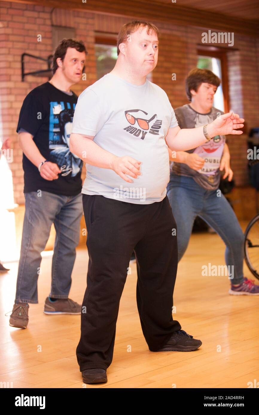 Exercise class for disabled people. Man with Down syndrome at a Zumba