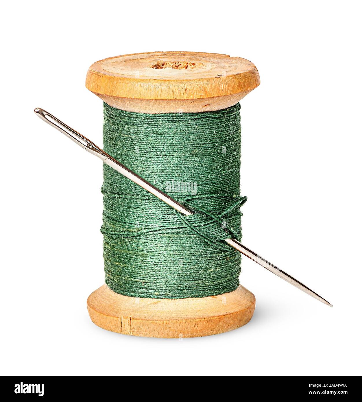 Needle and thread on wooden spool vertically Stock Photo