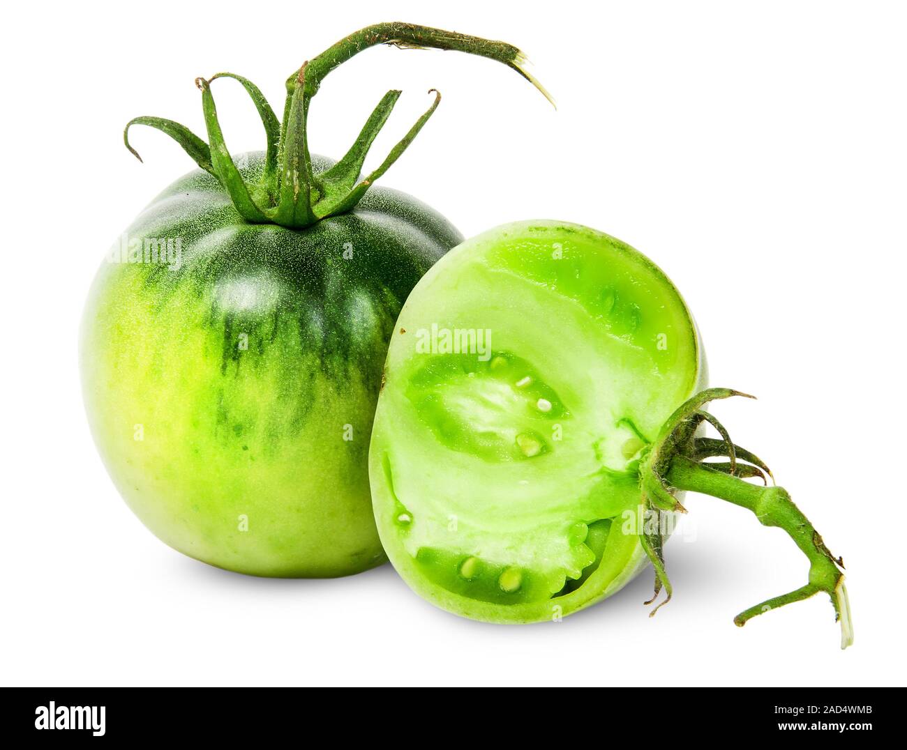 Whole and half green tomatoes Stock Photo - Alamy