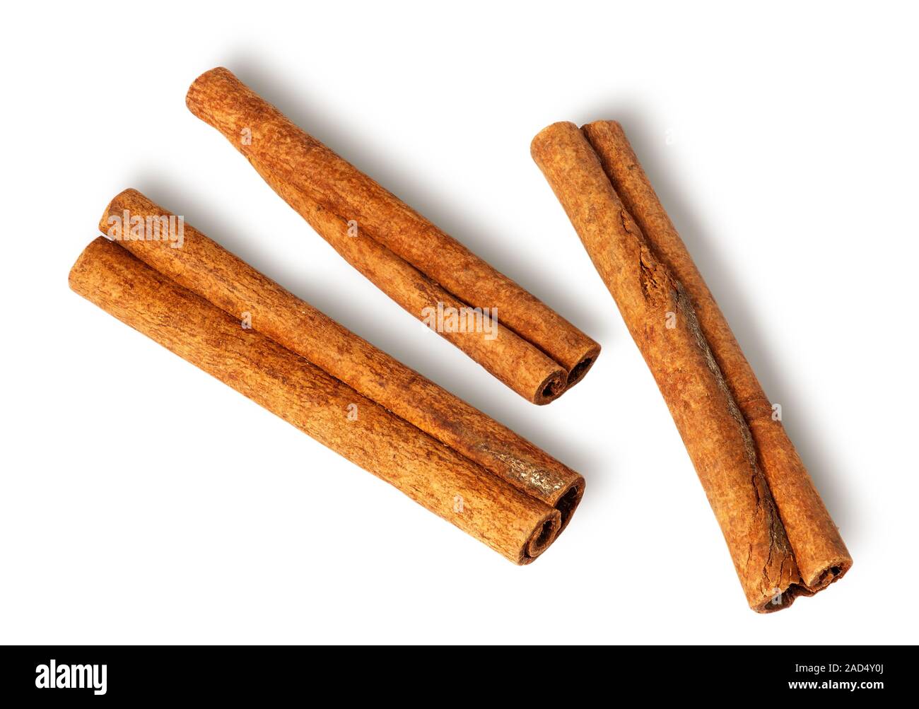 Three cinnamon sticks lie nearby Stock Photo