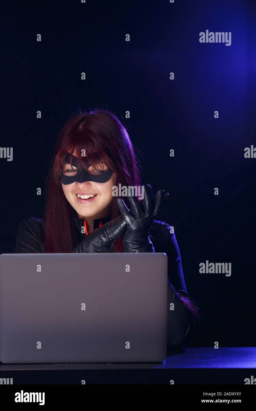 Brunette thief in black mask Stock Photo