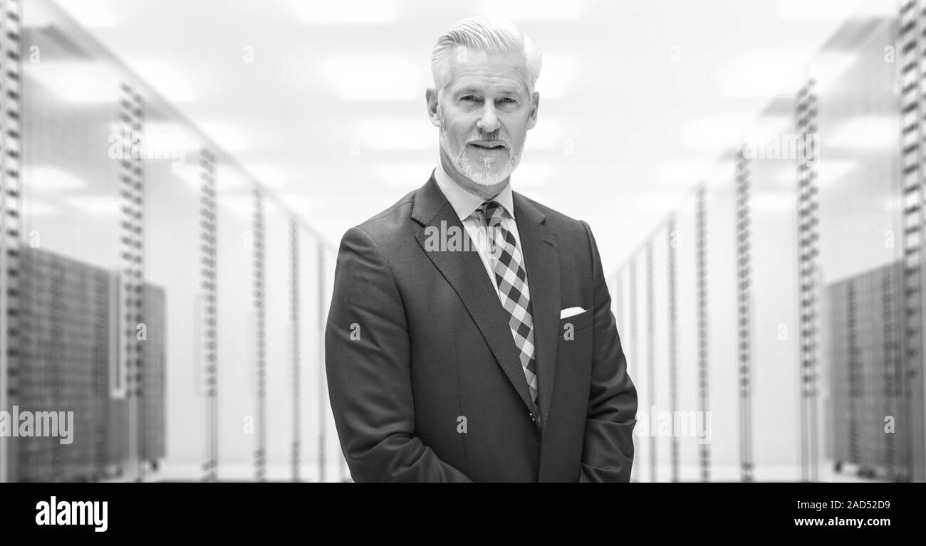 Senior Businessman in server room Stock Photo