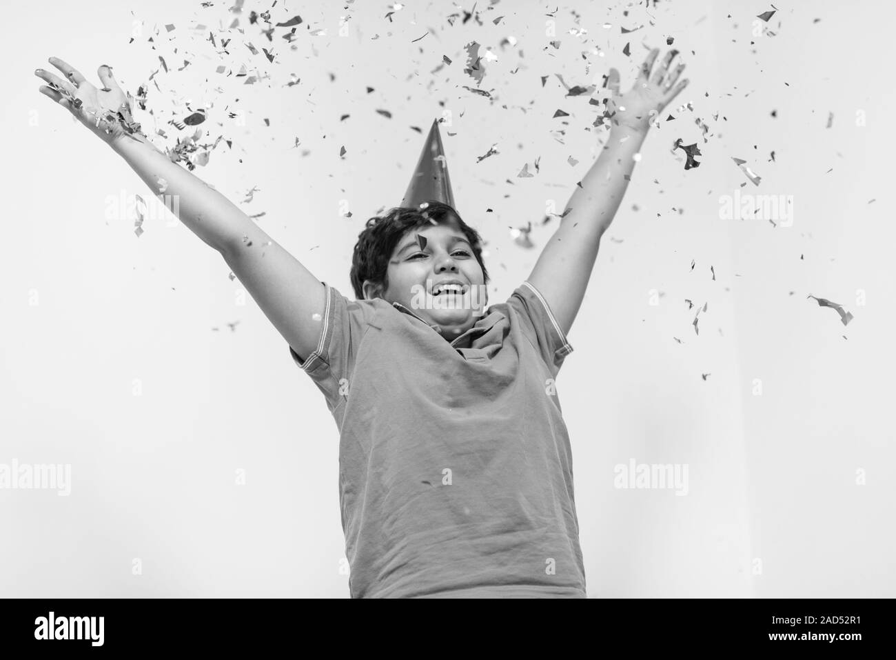 kid blowing confetti Stock Photo