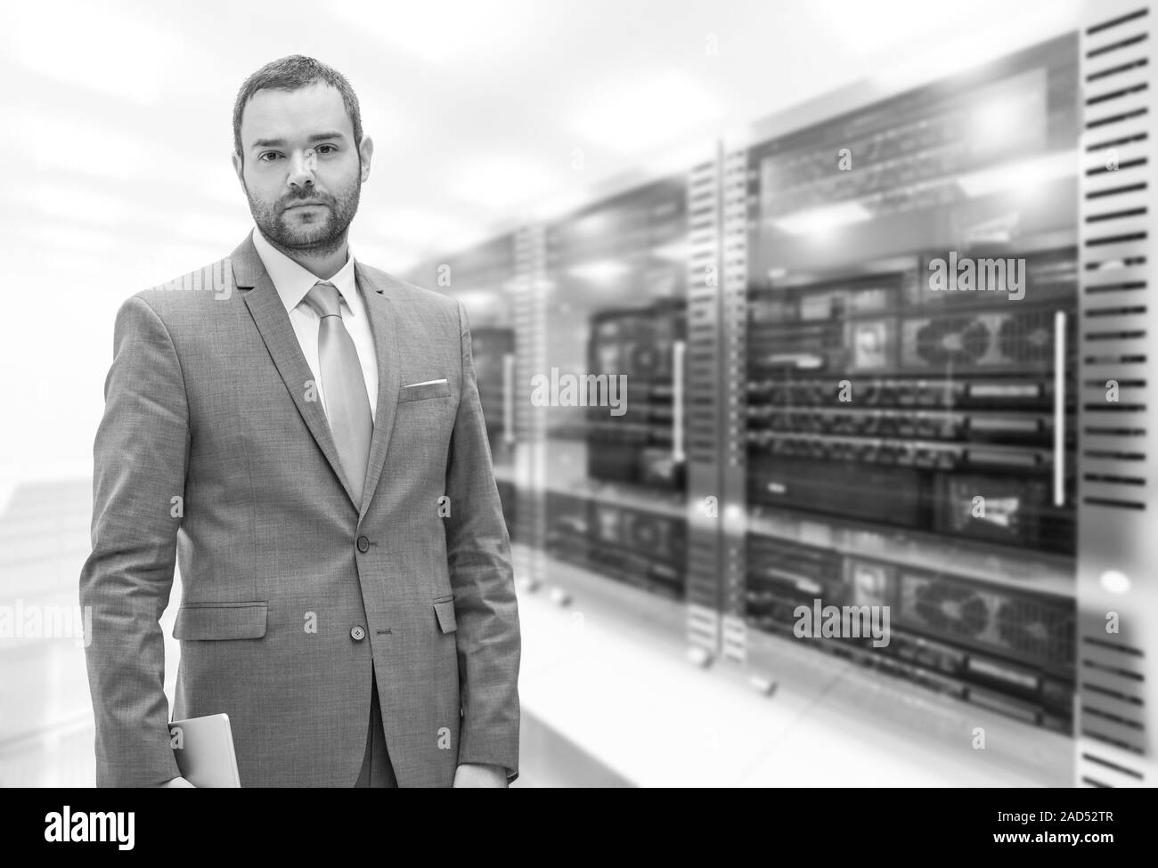 Young Businessman in server room Stock Photo