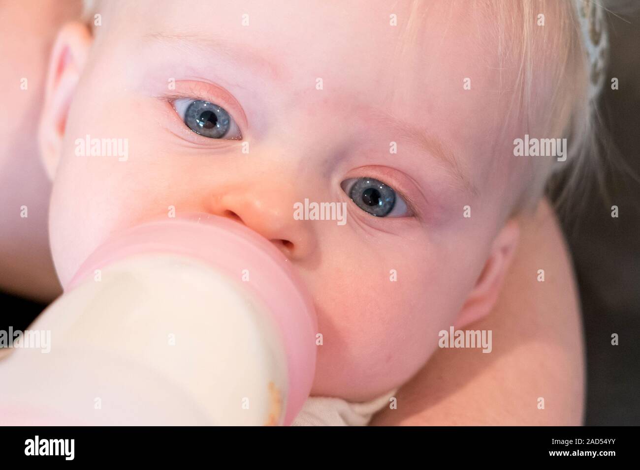 Mother Bottle Feeding Cute Baby Close Up, Drinking Formula, Age - 6 Months Stock Photo