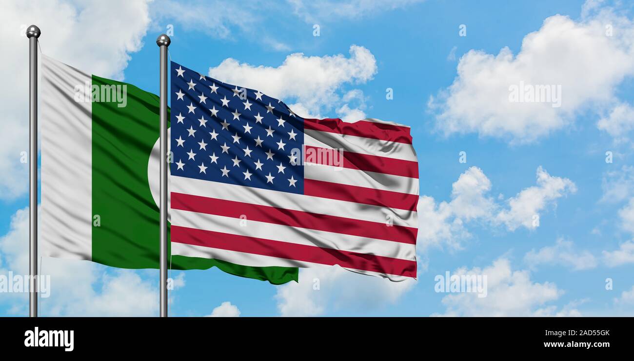Pakistan and United States flag waving in the wind against white cloudy blue sky together. Diplomacy concept, international relations. Stock Photo