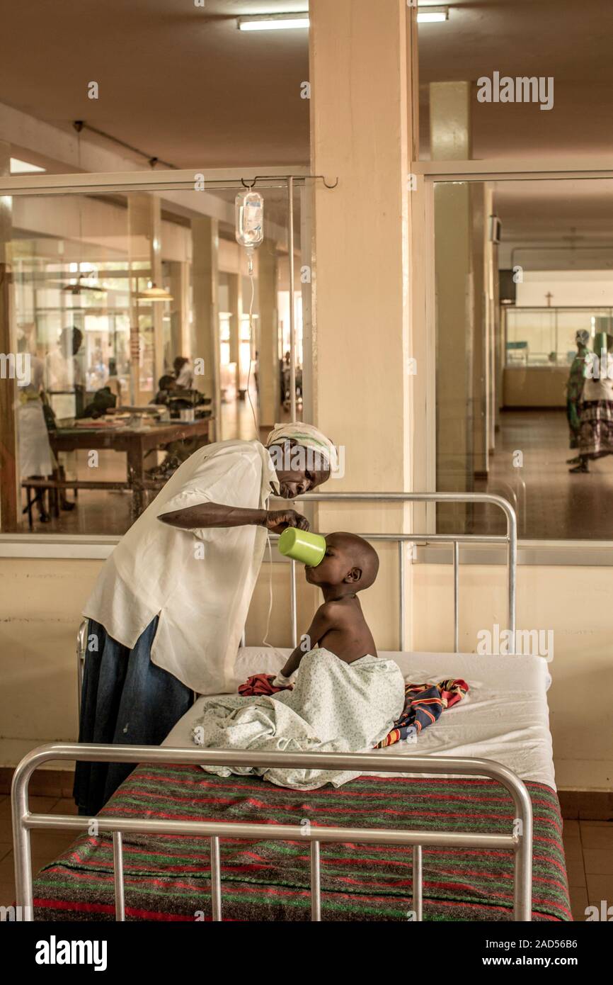 Mother and sick child in hospital. The mother is providing her child